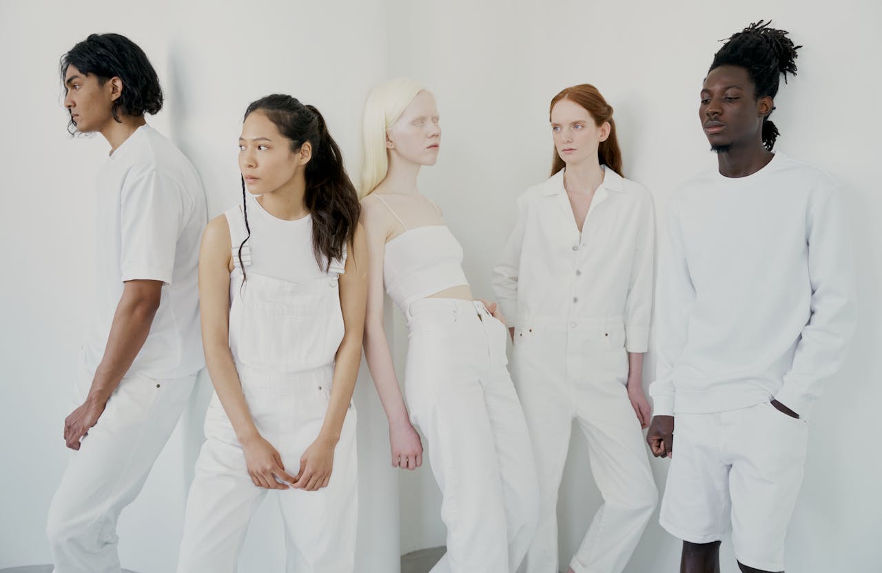The Art of Drawing Readers In: Your attractive post title goes here A diverse group of people posing in stylish all-white outfits against a minimalist background.
