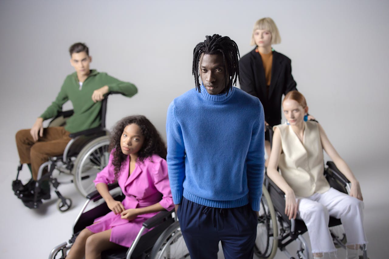 The Art of Drawing Readers In: Your attractive post title goes here Diverse group of people including individuals in wheelchairs, studio setting, white background.